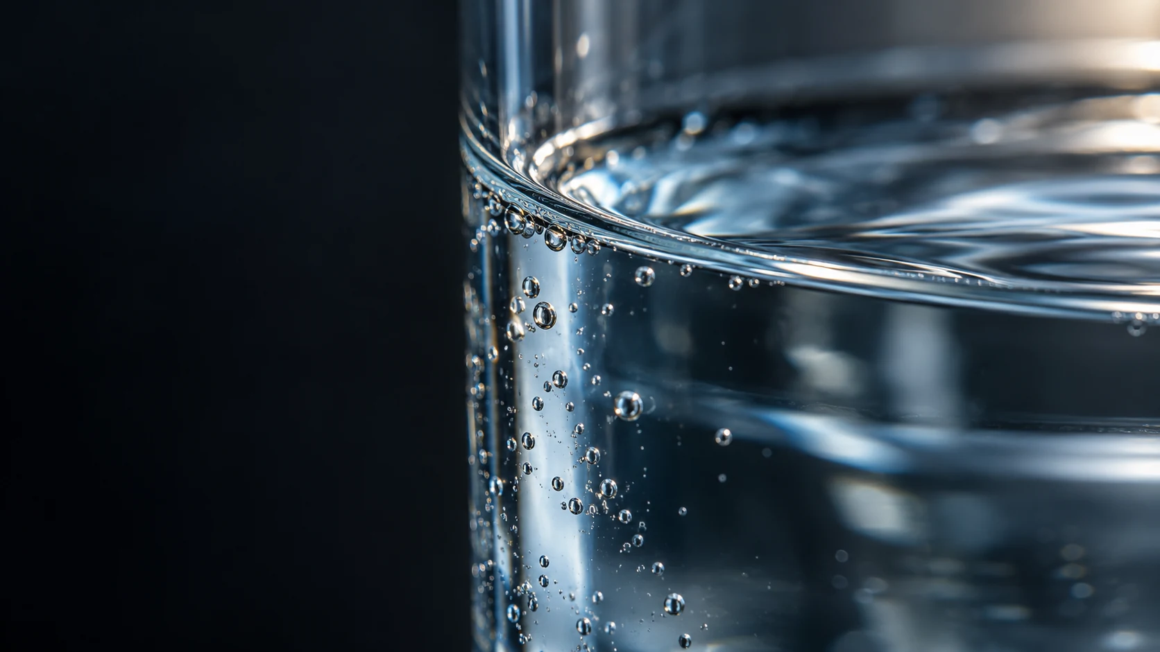 Detalle de la superficie del agua en un recipiente de vidrio